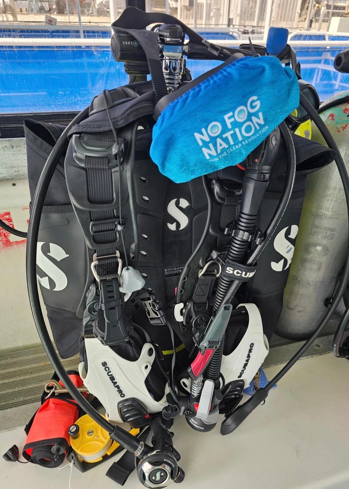 No Fog Nation microfiber mask cover on a Scubapro BCD rig staged on a dive boat